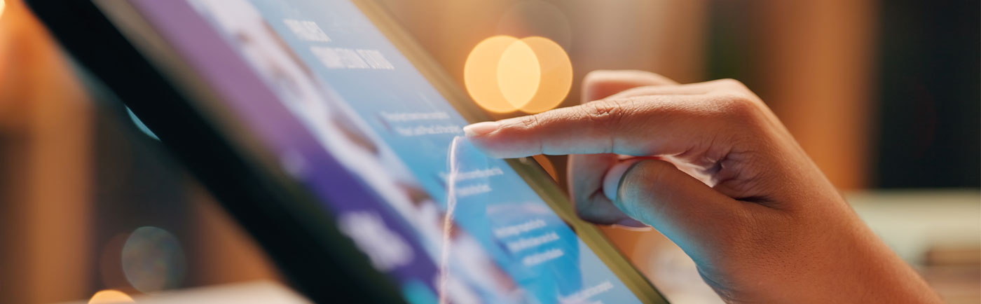 A person looking up information online on a tablet