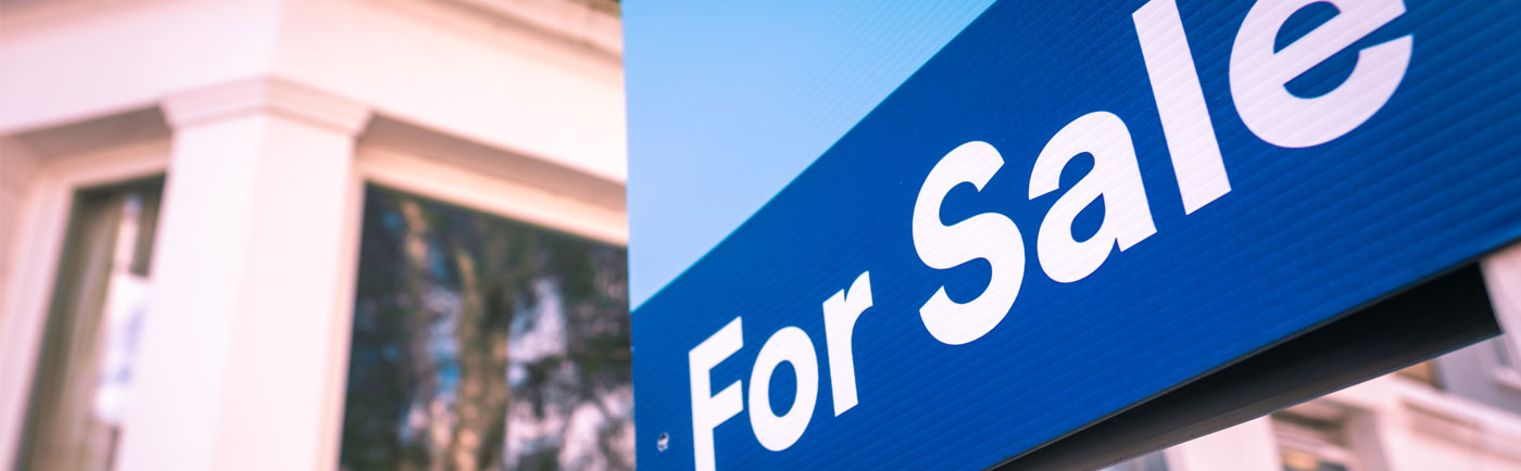 For sale sign in front of an available business property