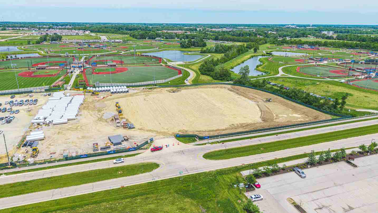 Aerial view of development site beside sports fields and roadway