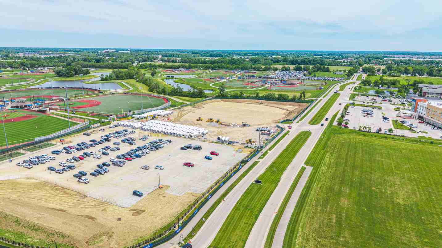 Aerial view of development site, parking area, and surrounding roads