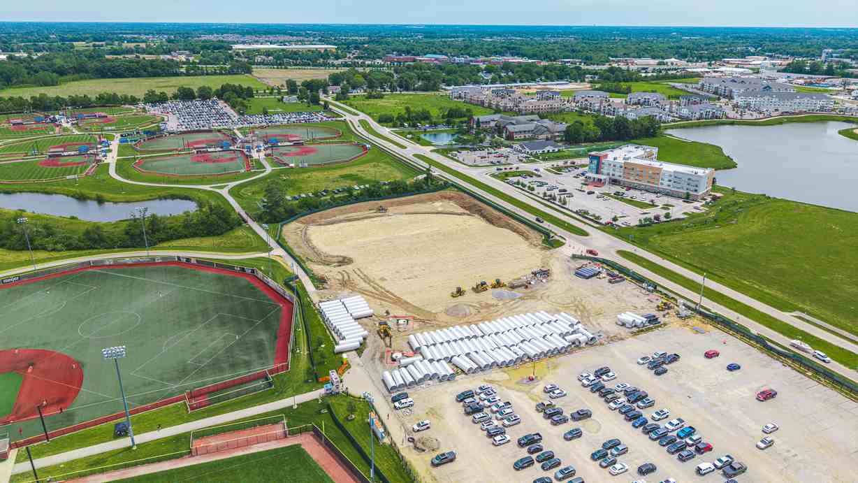 Aerial view of development site near sports fields and nearby buildings